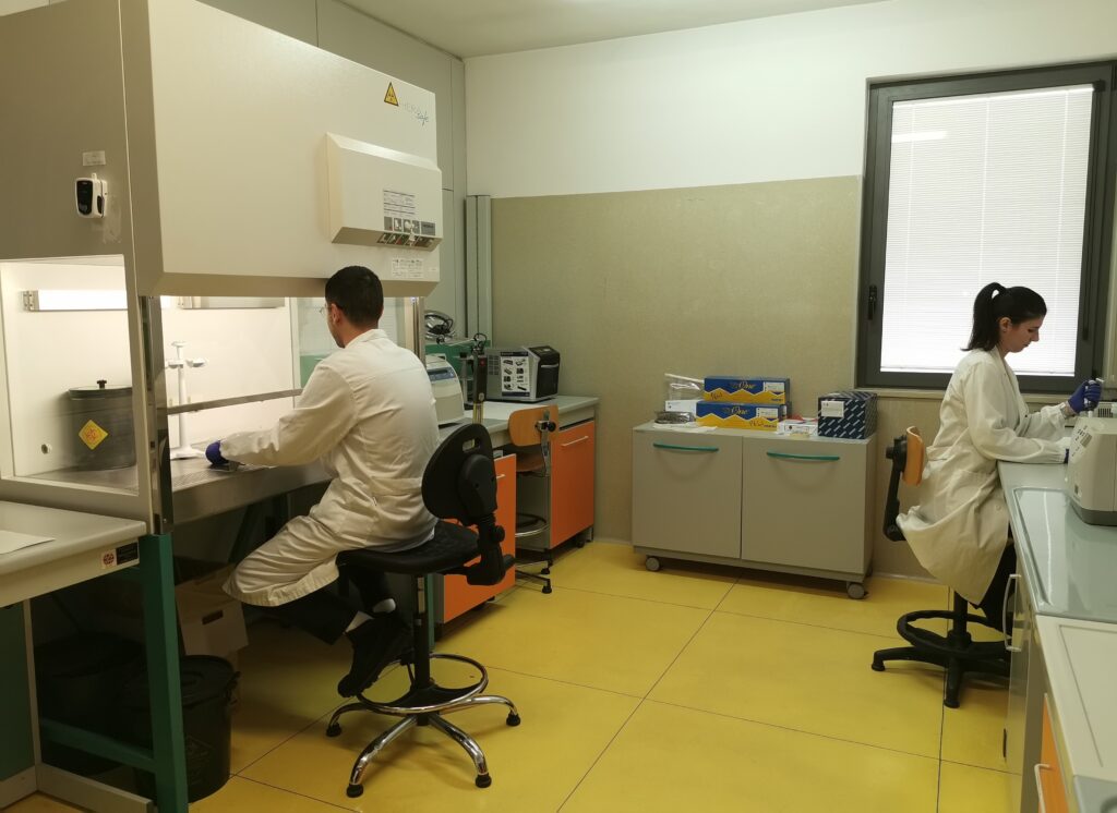 Scientists in lab coats performing genetical analyses